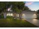 Charming single-Gathering home featuring a well-manicured lawn and an attached two-car garage at 14841 Faversham Cir, Orlando, FL 32826