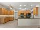 Spacious kitchen with wooden cabinetry, granite countertops, and stainless steel appliances at 14841 Faversham Cir, Orlando, FL 32826