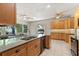 Bright kitchen features granite counters, wood cabinets, and access to the outdoor living area at 14841 Faversham Cir, Orlando, FL 32826