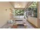 Enclosed lanai with brick flooring, ceiling fan, and views to the surrounding greenery at 14841 Faversham Cir, Orlando, FL 32826