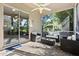 Screened lanai with a view to the backyard, complete with stylish patio furniture and a ceiling fan at 14841 Faversham Cir, Orlando, FL 32826
