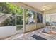 Screened-in lanai featuring brick flooring and a view of the lush outdoor space at 14841 Faversham Cir, Orlando, FL 32826