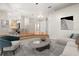 Open-concept living area with hardwood floors, neutral walls, and a view of the dining area and front entryway at 14841 Faversham Cir, Orlando, FL 32826