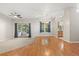 Bright living area with hardwood and carpet flooring, natural light, and access to the outdoor space at 14841 Faversham Cir, Orlando, FL 32826