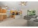 Open-concept living area with kitchen, perfect for entertaining, features a cozy gray couch at 14841 Faversham Cir, Orlando, FL 32826