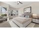 Bright bedroom with many windows, neutral walls, and a comfortable bed with stylish linens at 14841 Faversham Cir, Orlando, FL 32826