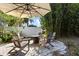 Charming backyard patio features an umbrella, brick pavers, and comfortable seating at 14841 Faversham Cir, Orlando, FL 32826