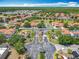 Discover a vibrant community with lush green spaces and tile roofs in this captivating aerial view at 16604 Caribbean Breeze Way, Clermont, FL 34714