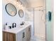 Bathroom featuring double sinks, updated vanity, and glass shower enclosure at 16604 Caribbean Breeze Way, Clermont, FL 34714