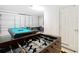 Spacious game room area offering a foosball table, pool table, and air hockey for endless hours of entertainment at 16604 Caribbean Breeze Way, Clermont, FL 34714