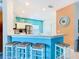 Bright and spacious kitchen with a breakfast bar featuring seating for four and modern appliances at 16604 Caribbean Breeze Way, Clermont, FL 34714