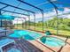 Relaxing screened-in pool area with a spa, comfortable lounge chairs, and a serene view at 16604 Caribbean Breeze Way, Clermont, FL 34714