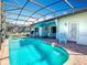 Inviting pool area with a hot tub, lounge chairs, and outdoor dining set for relaxing and entertaining at 16604 Caribbean Breeze Way, Clermont, FL 34714