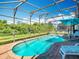 Enjoy the refreshing pool with screen enclosure and sunny blue umbrella for a relaxing outdoor experience at 16604 Caribbean Breeze Way, Clermont, FL 34714