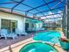 Inviting pool with a covered patio, comfortable lounge chairs, and picturesque backyard views for relaxation at 16604 Caribbean Breeze Way, Clermont, FL 34714