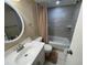 Cozy bathroom featuring a shower-tub combo and a large, well-lit vanity with ample counter space at 170 Palmetto Woods Ct # 1A, Deltona, FL 32725