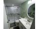 Bathroom with updated vanity, and walk-in shower with glass doors at 170 Palmetto Woods Ct # 1A, Deltona, FL 32725