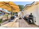 Back deck with barbeque, seating, and umbrellas creating a lovely outdoor entertaining space at 17409 Division St, Montverde, FL 34756