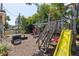 Backyard featuring playground equipment, a patio set, and fire pit for fun Gathering activities at 17409 Division St, Montverde, FL 34756