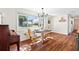 Cozy dining area with natural light, hardwood floors, and a charming chandelier at 17409 Division St, Montverde, FL 34756