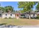 Inviting single-Gathering home showcasing a well-maintained lawn, solar panels, and charming curb appeal at 17409 Division St, Montverde, FL 34756