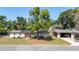 Charming single-story home with a well-manicured lawn and a detached carport, perfect for comfortable living at 17409 Division St, Montverde, FL 34756