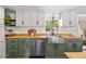 Charming kitchen featuring butcher block counters, stainless steel appliances, and shaker style cabinets at 17409 Division St, Montverde, FL 34756