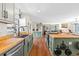 Well-lit kitchen with butcher block countertops, stainless steel sink, and a large kitchen island at 17409 Division St, Montverde, FL 34756