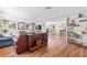 Open concept living room featuring wood flooring and seamless flow to the dining area at 17409 Division St, Montverde, FL 34756
