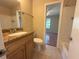 Neutral bathroom boasts a granite countertop vanity and tub with shower, providing a functional space at 208 Afton Sq # 307, Altamonte Springs, FL 32714