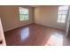 This bedroom features wood flooring, natural light from two bright windows, and a welcoming feel at 208 Afton Sq # 307, Altamonte Springs, FL 32714