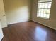 Cozy bedroom features wood flooring and a bright window, offering a comfortable and inviting space at 208 Afton Sq # 307, Altamonte Springs, FL 32714