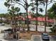 View of Oasis at Pearl Lake buildings with red roofs through trees at 208 Afton Sq # 307, Altamonte Springs, FL 32714