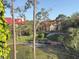 A serene view of Oasis at Pearl Lake community buildings with red roofs at 208 Afton Sq # 307, Altamonte Springs, FL 32714