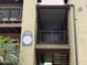 Condominium building featuring stairs leading to upper units and a unit number on the building at 208 Afton Sq # 307, Altamonte Springs, FL 32714