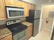 Well-equipped kitchen features granite countertops, stainless steel appliances, and a laundry closet at 208 Afton Sq # 307, Altamonte Springs, FL 32714
