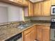 Well-maintained kitchen features granite countertops, wood cabinets, and stainless sink at 208 Afton Sq # 307, Altamonte Springs, FL 32714