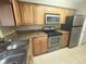 Functional kitchen boasts granite countertops, stainless steel appliances, and ample cabinet space at 208 Afton Sq # 307, Altamonte Springs, FL 32714