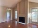 Bright living room featuring a fireplace, wood floors, and balcony access at 208 Afton Sq # 307, Altamonte Springs, FL 32714