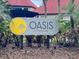 Elegant community sign with lush tropical landscaping at Oasis at Pearl Lake at 224 Afton Sq # 301, Altamonte Springs, FL 32714