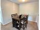 Dining area with dark wood table and four chairs, perfect for Gathering meals at 224 Afton Sq # 301, Altamonte Springs, FL 32714