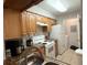 Well-lit kitchen with wooden cabinets, granite countertops, and white appliances at 224 Afton Sq # 301, Altamonte Springs, FL 32714