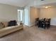 Cozy living room with sofa, dining area and view of the bedroom at 224 Afton Sq # 301, Altamonte Springs, FL 32714