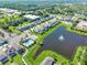 An aerial view of the community featuring the pond with fountain and community pool at 2264 Emerald Springs Dr, Apopka, FL 32712