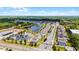 An aerial of the neighborhood featuring modern homes, mature trees, and a tranquil lake with a fountain at 2264 Emerald Springs Dr, Apopka, FL 32712