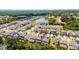 Aerial view of a home with a tree lined street and lake beyond the neighborhood at 2264 Emerald Springs Dr, Apopka, FL 32712