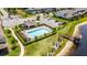 Aerial view of a community pool, cabana, and a dock overlooking a serene pond at 2264 Emerald Springs Dr, Apopka, FL 32712