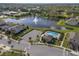 Community aerial featuring a pool, clubhouse, pond with fountain, and manicured green spaces at 2264 Emerald Springs Dr, Apopka, FL 32712
