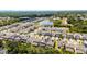 A beautiful aerial view showcasing the neighborhood, homes, and a picturesque lake with fountain at 2264 Emerald Springs Dr, Apopka, FL 32712