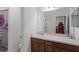 Bathroom view featuring a wooden vanity, sink, toilet, and a partial view of the shower curtain at 2264 Emerald Springs Dr, Apopka, FL 32712